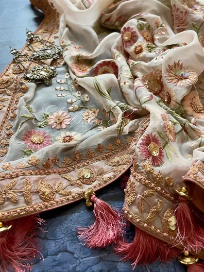 A detail shot of the dupatta's border, with its Doriwork and sequin highlights.