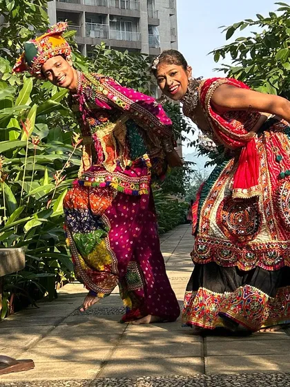 A fun, candid shot that captures the playful side of Navratri. This couple is clearly enjoying every moment in their matching outfits.
