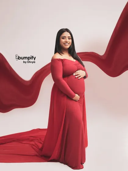 A joyful and radiant smile from the mom-to-be in her elegant red gown. This shot is all about capturing the pure happiness of this special time.