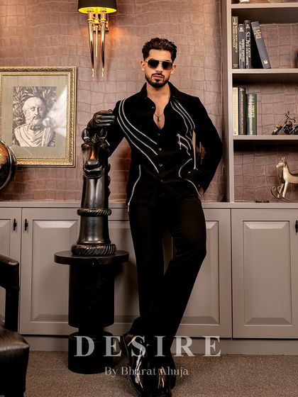 Leaning on a chess piece, this shot symbolizes the strategic and powerful nature of this tailored black shirt.