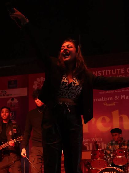 On stage with a live band behind me at the Tecnia Institute Media Fest. This is me in my element, feeding off the crowd's energy and giving it right back.