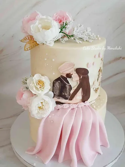 For this engagement cake, I hand-painted a portrait of the lovely Sikh couple, creating a truly personal centerpiece for their celebration. The cake is decorated with delicate sugar flowers and a touch of gold leaf for an elegant finish.