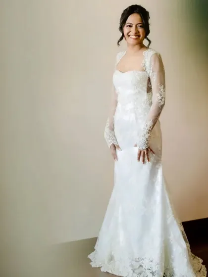 A full-length view of my lovely Catholic bride, looking absolutely serene and elegant. Her custom lace gown is complemented by a soft, romantic makeup look and a classic bridal updo, all designed to create a timeless and graceful silhouette for her walk down the aisle.