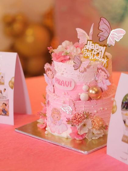 The angel-themed cake as the centerpiece of a beautifully decorated birthday party.