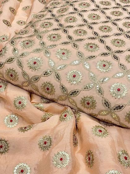 A close-up of the peach Chinon fabric, emphasizing the craftsmanship of the Gotta Patti and sequin work. It’s a beautiful choice for wedding guest outfits.