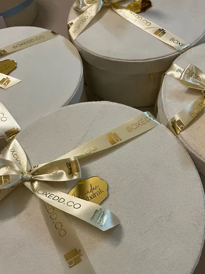 A collection of my signature white velvet boxes with custom branded ribbons, ready for Ramadan and Eid deliveries.