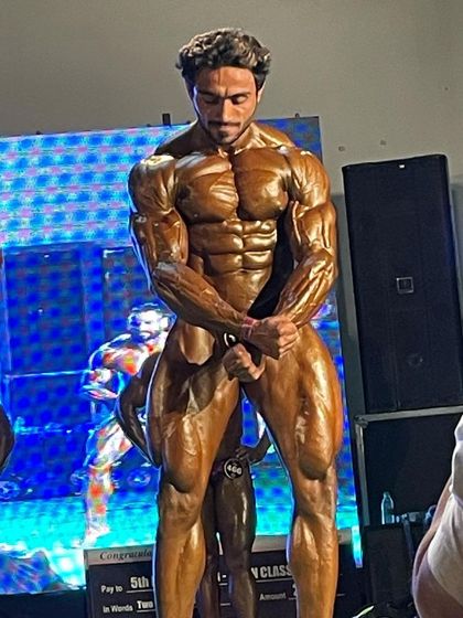 Front double bicep pose on stage.