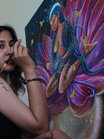 A moment of focus while working on the intricate details of the lotus and the figure, channeling a sense of peace into the brushstrokes.