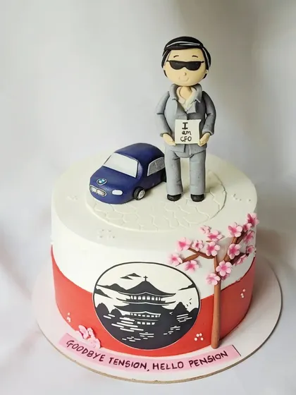 "Goodbye Tension, Hello Pension." This farewell cake for a CFO captures his entire story. It features a hand-sculpted figurine in a suit, his beloved BMW, and a beautiful hand-painted panel depicting his love for Japan, complete with cherry blossoms.