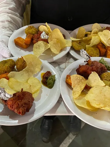 Our staff serving plates of delicious and varied starters to guests.