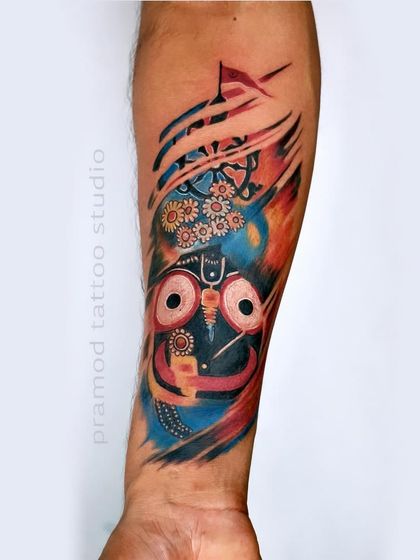 A stunning, colorful Lord Jagannath tattoo. The abstract, paint-stroke style gives it a modern and artistic feel while honoring the traditional form of the deity.