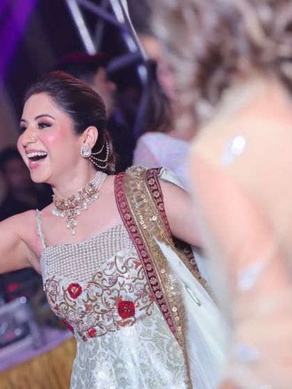A guest with a radiant smile on the dance floor at a Diwali party. Her happiness is contagious and perfectly captures the spirit of the celebration.