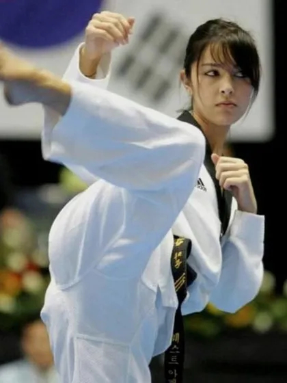 It's the size of the fight in the girl that matters. This student shows intense focus during a Taekwondo move, proving that technique and determination overcome size.