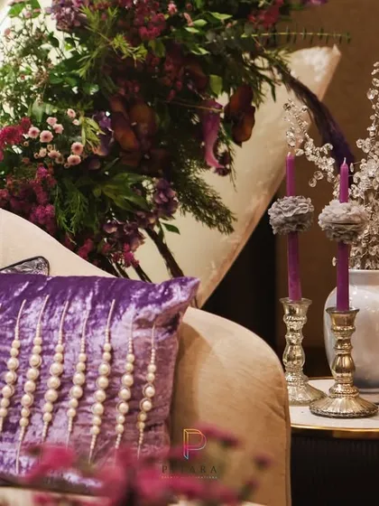 Texture and detail are everything. A close-up of the plush, pearl-studded velvet cushion, which adds another layer of luxury and tactile richness to the lounge seating.
