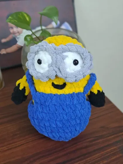 A very soft and cuddly Minion toy, made with plush velvety yarn. His overalls and goggles are carefully stitched to match the character from the movies.