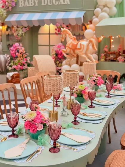 A stunning view of the scalloped-edge table, showcasing the wicker lamps, floral arrangements, and carefully layered place settings.