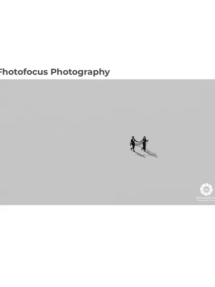 This award-winning photograph showcases our fine-art approach. The minimalist composition and dramatic shadows create a powerful, artistic statement about two people walking their path together.