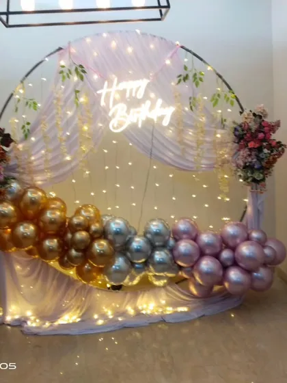 A close-up of the neon sign and balloon garland on the round backdrop, perfect for any chic celebration.