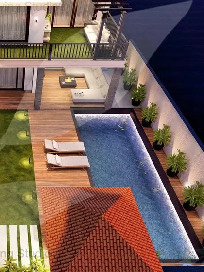 This backyard design for a Tatvam Villas property includes a beautiful swimming pool with a wooden deck, lounge chairs, and a separate patio area with a fire pit, creating a complete resort-style experience at home.