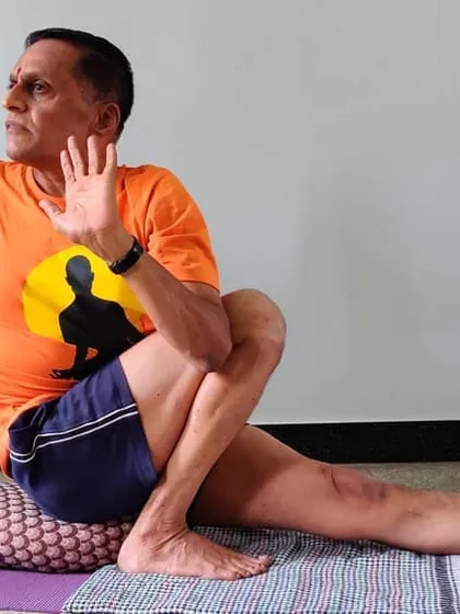 A different angle of Marichyasana 3, showing the open palm which encourages the opening of the chest during the twist.