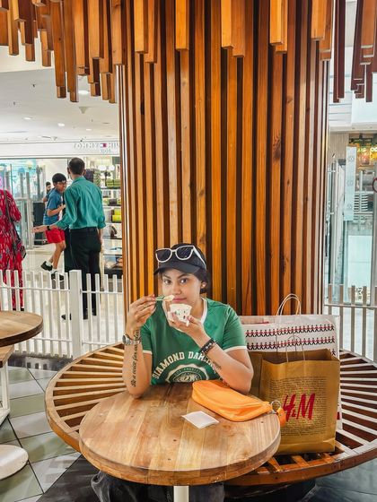 Taking a break with some ice cream after a shopping session, a relatable and sweet moment.