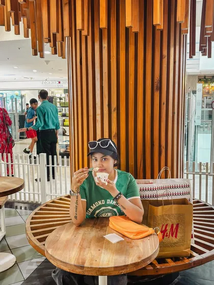 Taking a break with some ice cream after a shopping session, a relatable and sweet moment.