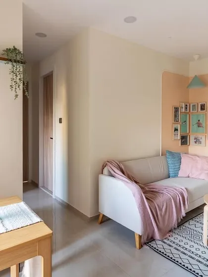 A view from the dining area towards the living space, showcasing the cohesive and uncluttered design that makes the apartment feel larger.