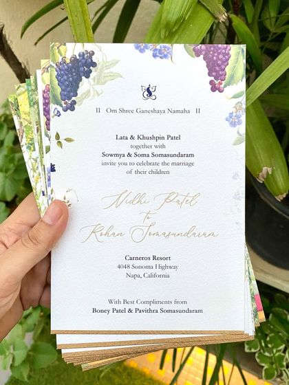 The main wedding invitation for the Napa wedding, featuring illustrations of grapes and vines. The elegant script and custom monogram tie the whole cross-cultural suite together.
