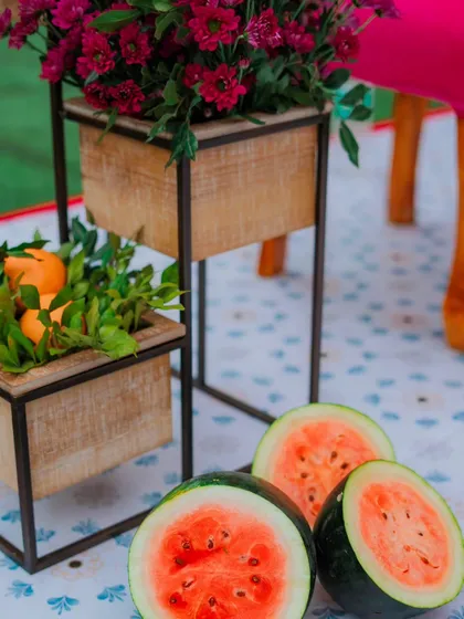 I believe in using fresh, natural elements in my decor. Sliced watermelons not only add a pop of colour but also a refreshing, summery vibe to this Mehendi setup.