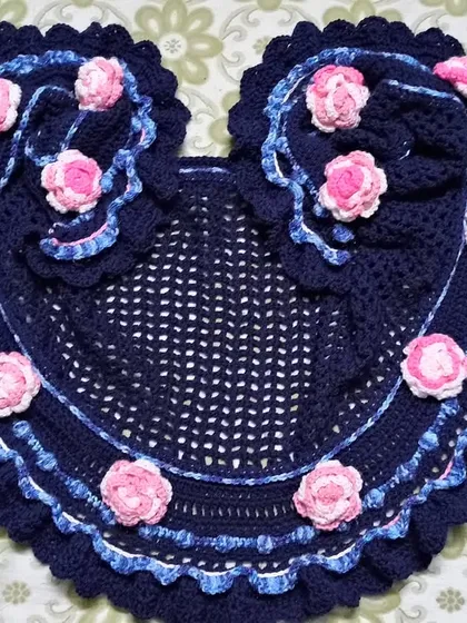 I was a pattern tester for this stunning 'Rainbow Among The Clouds' shawl. This heart-shaped design in navy blue is adorned with delicate pink roses and a ruffled edge.