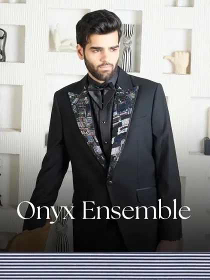 An artistic take on formalwear. This black tuxedo features a unique abstract printed lapel, offering a subtle yet impactful twist on a classic design for the man who appreciates fine details.