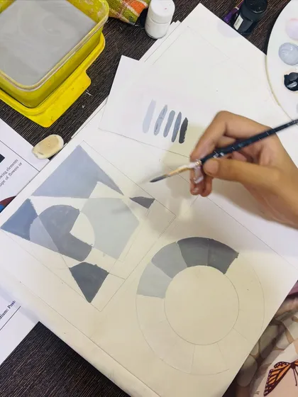 This image shows a student practicing tonal value scales and applying them to a geometric composition, a core exercise for the drawing grade exams.