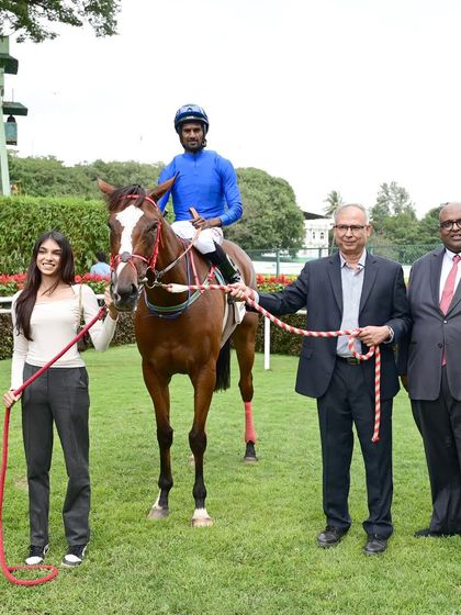 The winning horse Inspire, with jockey Antony Raj.S, poses with the owners after a successful run in The B.T.C. Workforce Cup.