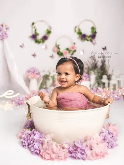 A joyful splash in a tub full of flowers. This first birthday session was full of smiles and happy splashes.