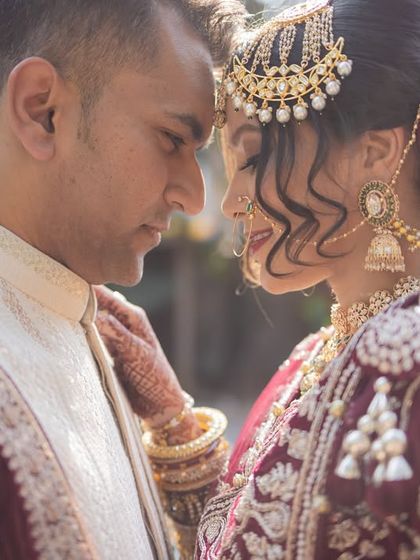 An intimate close-up of the couple, foreheads touching. This classic pose is all about showcasing the connection and love between two people.