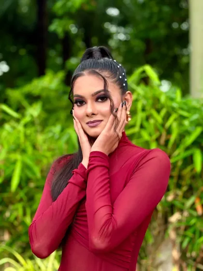 A beautiful pose that highlights the facial contouring and the details of the high-neck dress.