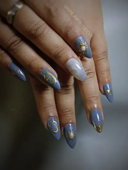 A closer look at the celestial nail art, with a marble accent nail.