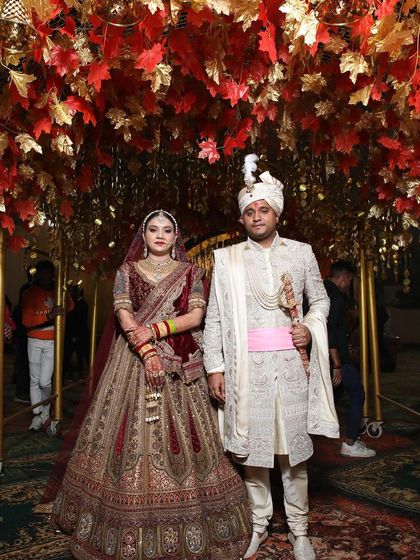 A beautiful couple under a canopy of autumn leaves. Such a grand and royal picture.
