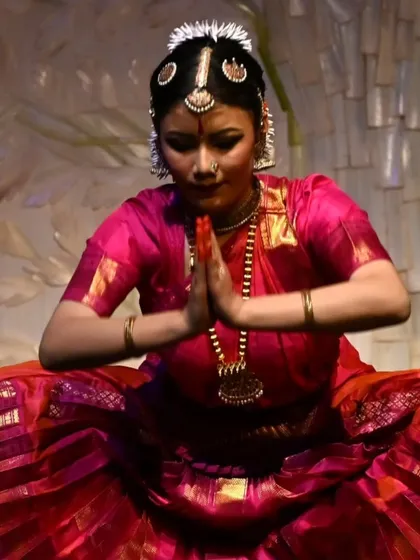 A moment of quiet introspection and prayer during Stuti Mukherjee's arangetram. The anjali mudra, or folded hands, signifies reverence and offering, a central theme in our dance.