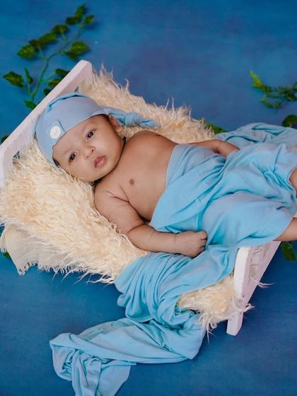 Pure perfection. This little one is chilling out in his miniature bed, surrounded by a sea of blue.
