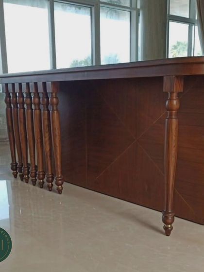 A classic wooden console table with multiple turned legs, designed as a sofa back table. The intricate woodwork and rich finish add a touch of traditional elegance.