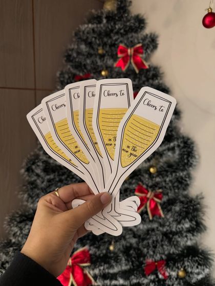 Every New Year deserves a custom cheers. These fun, champagne-glass-shaped cards are perfect for party props or as a unique way for guests to write down their resolutions at a house party.