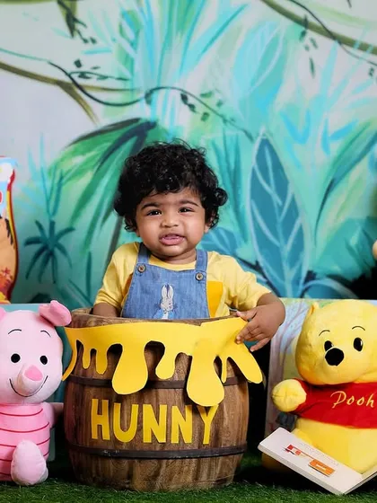 A classic Winnie the Pooh theme for a sitter session. Surrounded by friends from the Hundred Acre Wood, this little one is sitting in a "hunny" pot.