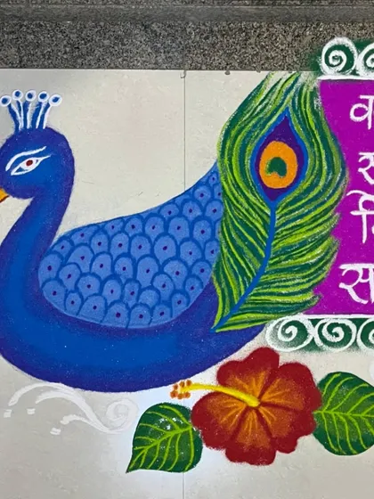 A different angle of the peacock and Ganesha shloka rangoli. This view highlights the vibrant blue of the peacock and the detailed rendering of the hibiscus flower.