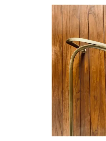 Another detail of the aged brass handrail, showing its elegant curve against a wood-paneled wall. The satisfaction comes from getting these small, tactile moments just right.