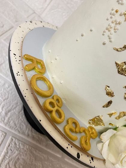 A close-up on the custom gold lettering we created for this beautiful cake.