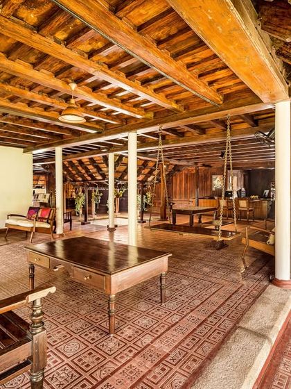 Another perspective of the Aranmula Palace lobby, showcasing the beautiful wooden architecture and comfortable seating areas that reflect royal hospitality.