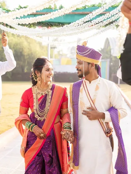 Walking into their forever. This couple looks picture perfect, with the bride's classic makeup and Paithani saree creating a timeless and elegant wedding day look.