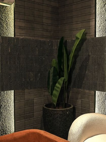 A corner detail showing our 'Ruptura' sandstone texture. The hydro jet treatment creates a unique, organic finish that elevates the material, making it suitable for both interior and exterior spaces.