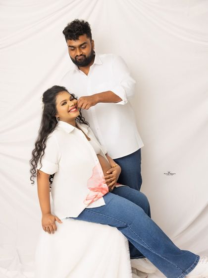 A fun and playful moment from a casual couple's maternity shoot. The husband-to-be teases his wife, and their laughter is infectious.